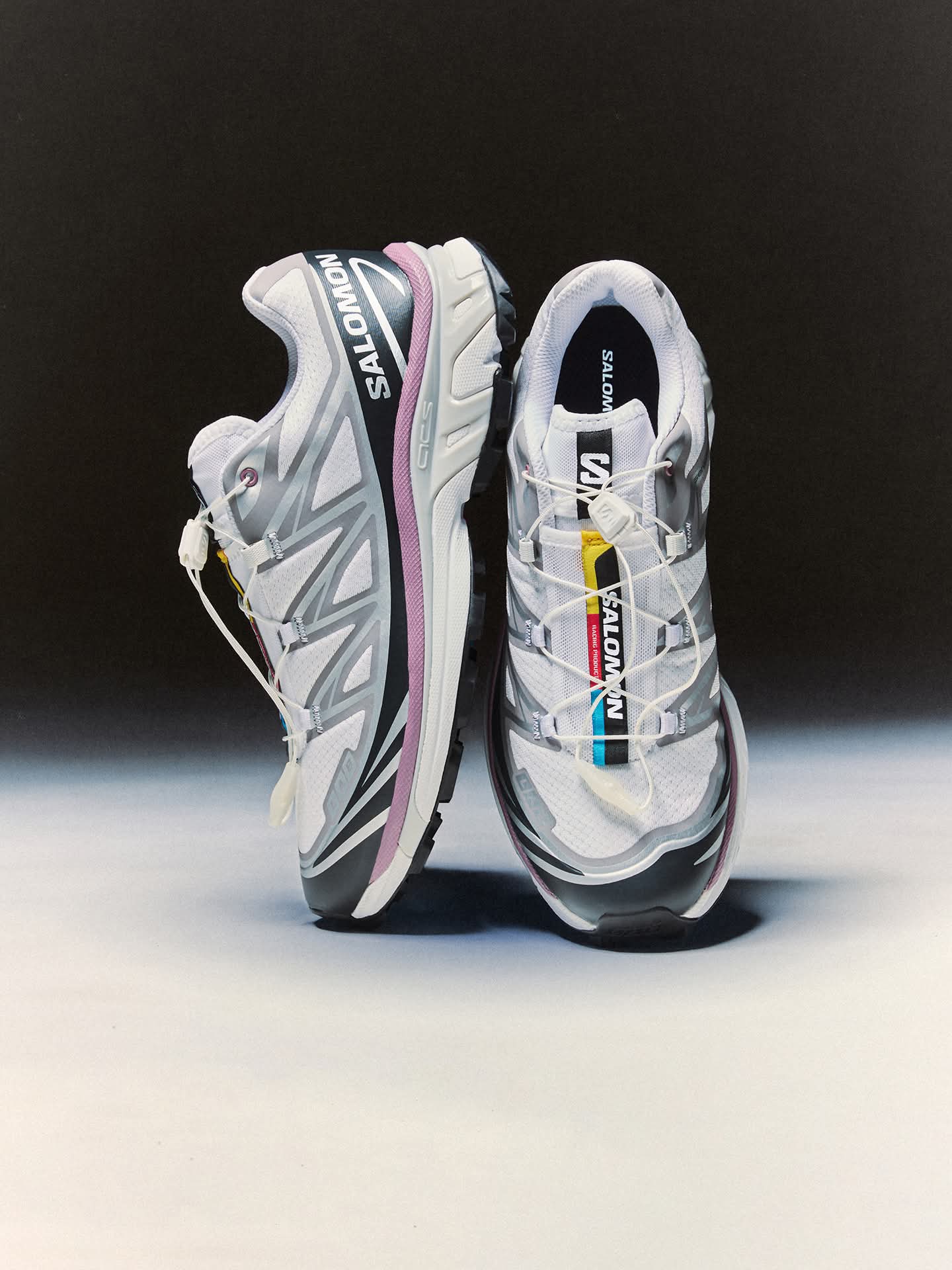 Pair of Salomon running shoes on a black and white background