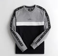 Gray and black sweatshirt with white accents on a light gray background