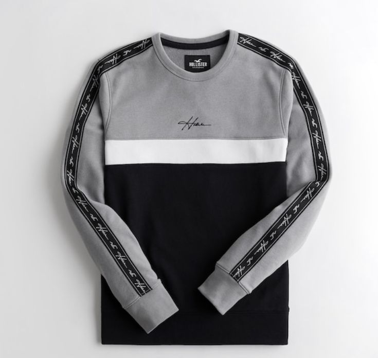 Gray and black sweatshirt with white accents on a light gray background