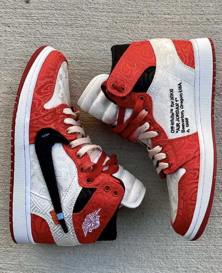 Red and white sneakers with black accents on a gray surface