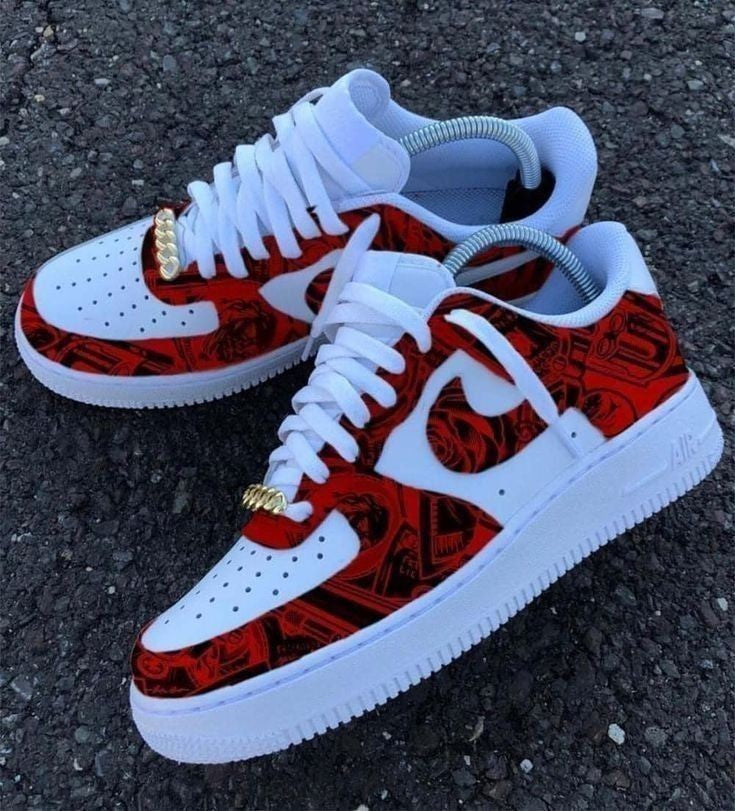 White sneakers with red and black pattern on a dark surface