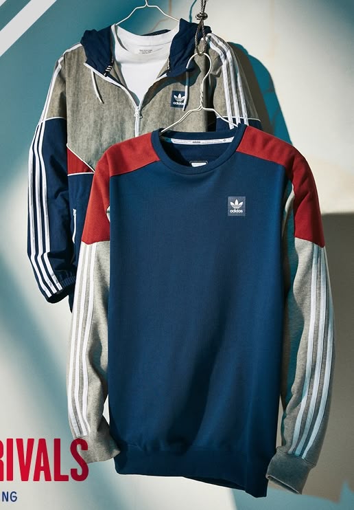 Adidas sweatshirt with color-block design on a hanger against a gradient background
